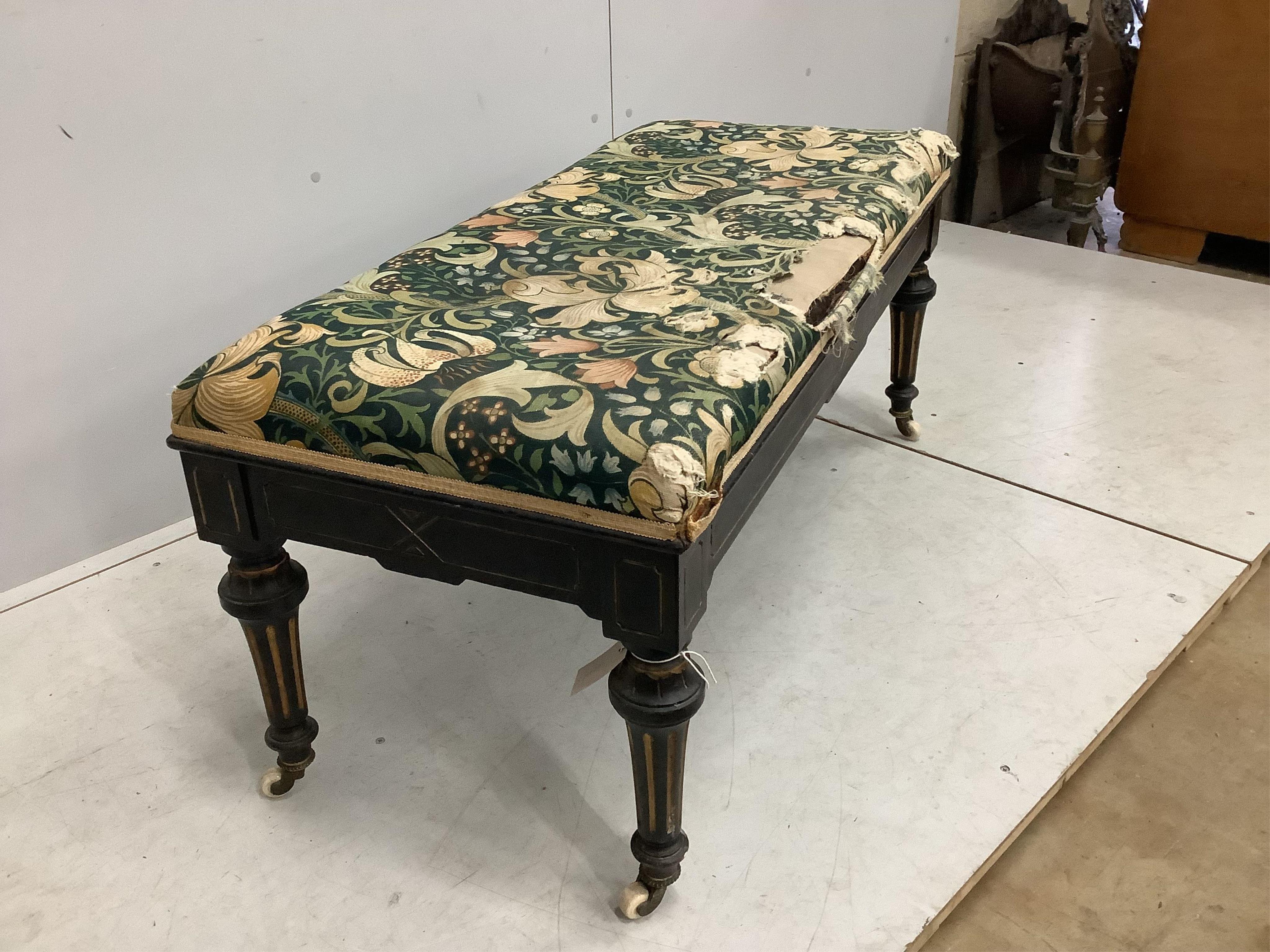 A late Victorian ebonised stool with hinged box seat, width 113cm, depth 49cm, height 50cm. Condition - fair, upholstery poor